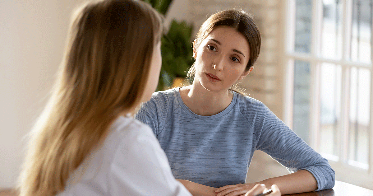 A woman discusses the potential risks of abortion with a healthcare professional.